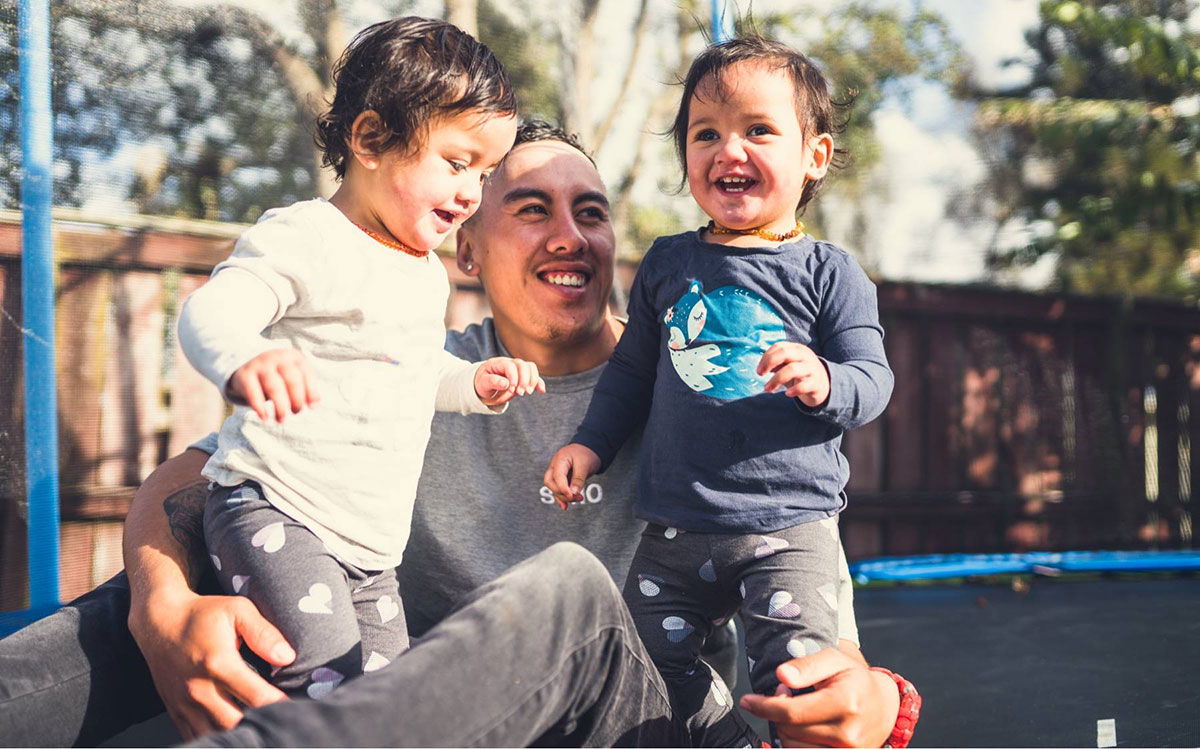 dad playing with children trampouline new zealand 